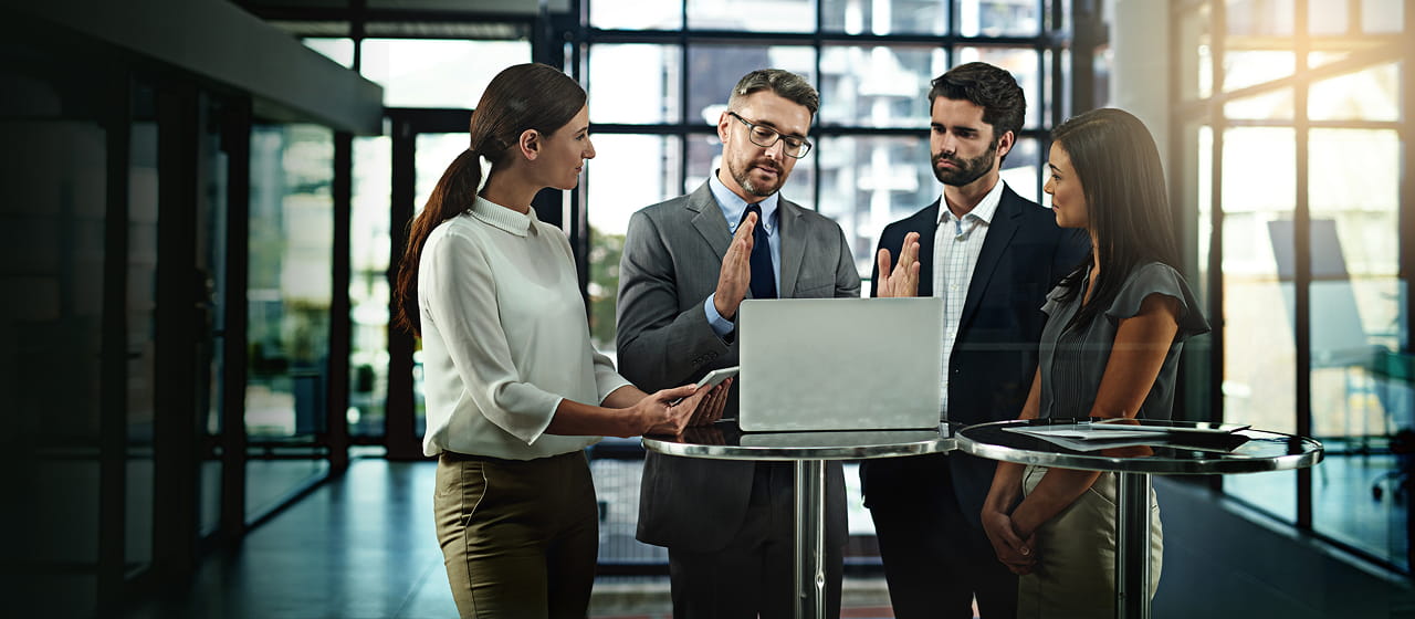 Corporate team discussing website operations and digital strategy during a business meeting in a modern office environment.